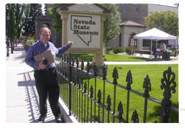 Southgate Coins owner Rusty Goes poses in front of the Nevada State Museum sign