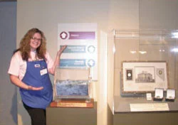 Southgate Coins employee Amy poses at the coin show with the grand prize