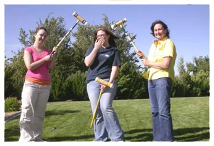 Maya and Marie bonk Amy on the head during croquet