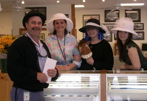Brian the Mailman poses with a bowler hat on Kentucky Derby Day at the coin shop