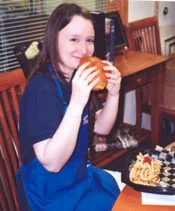 Maya poses with lunch at the coin shop