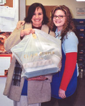 Marie and Amy pose with Free Lunch Friday at the coin shop
