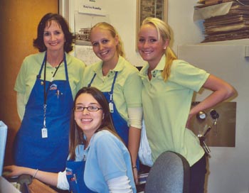 Southgate Coins owner Marie Goe and 3 employees hard at work