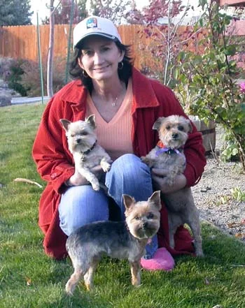 Southgate Coins owner Marie poses with the pups