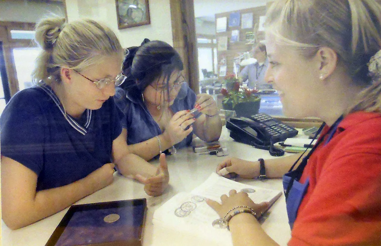Southgate Coins employee Rebecca offers customers coin value advice