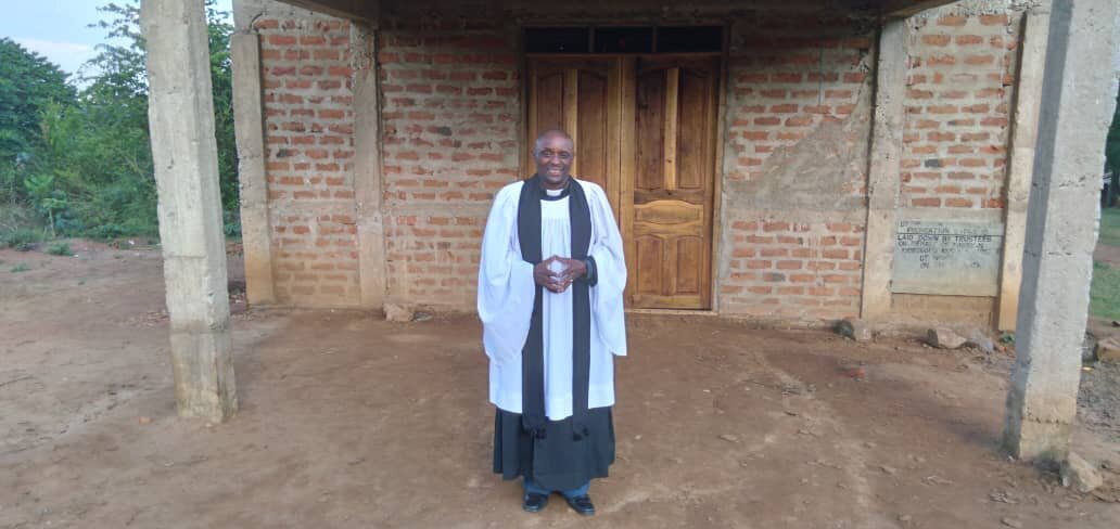 Pastor Phares Mwegalawa outside main door