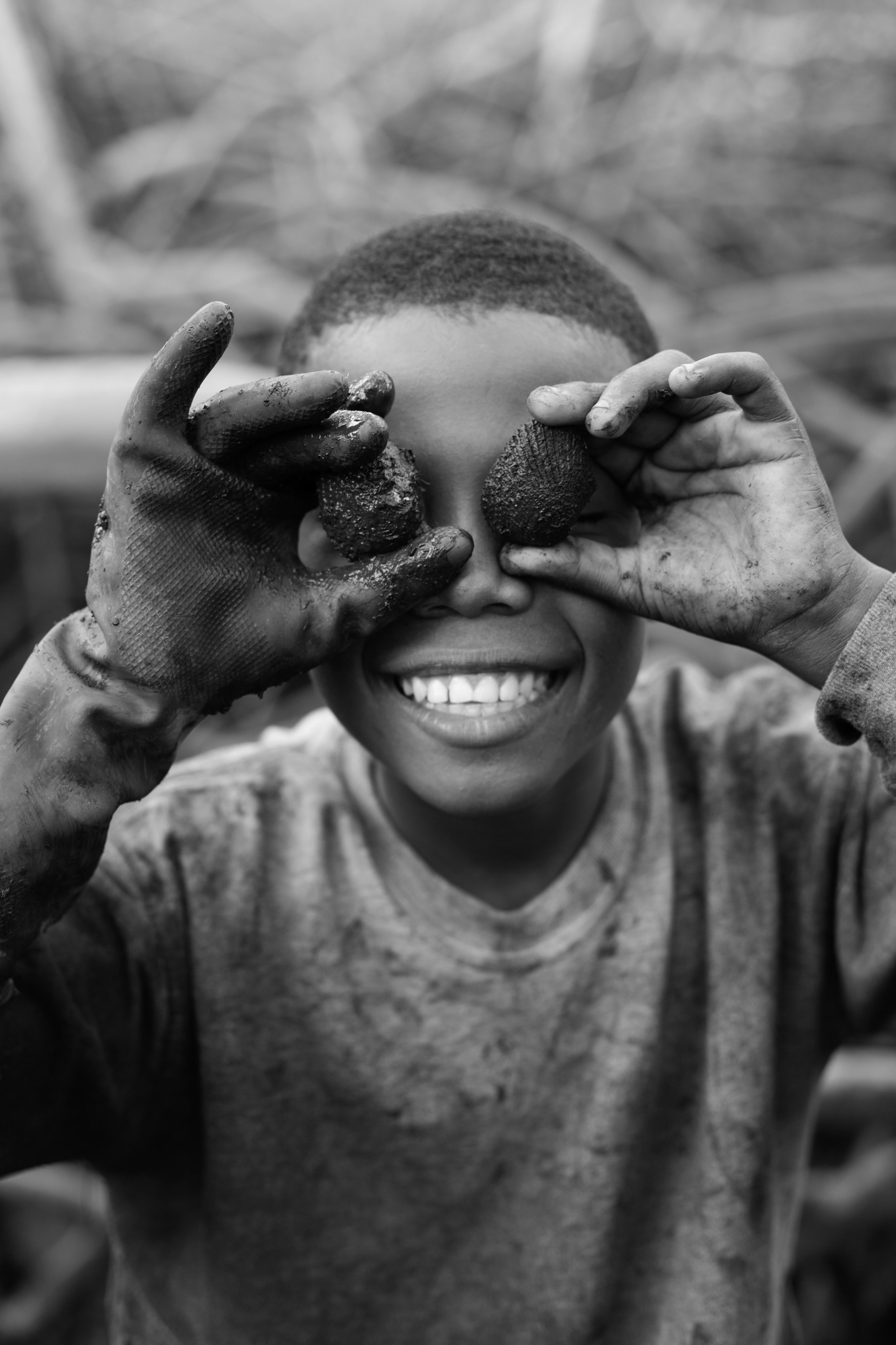  Efraín Montaño goofs around with the black shells he just picked in the Cayapas Mataje Mangrove Reserve. He has 5 brothers and sisters, 1 of which also picks shells. 2013. 