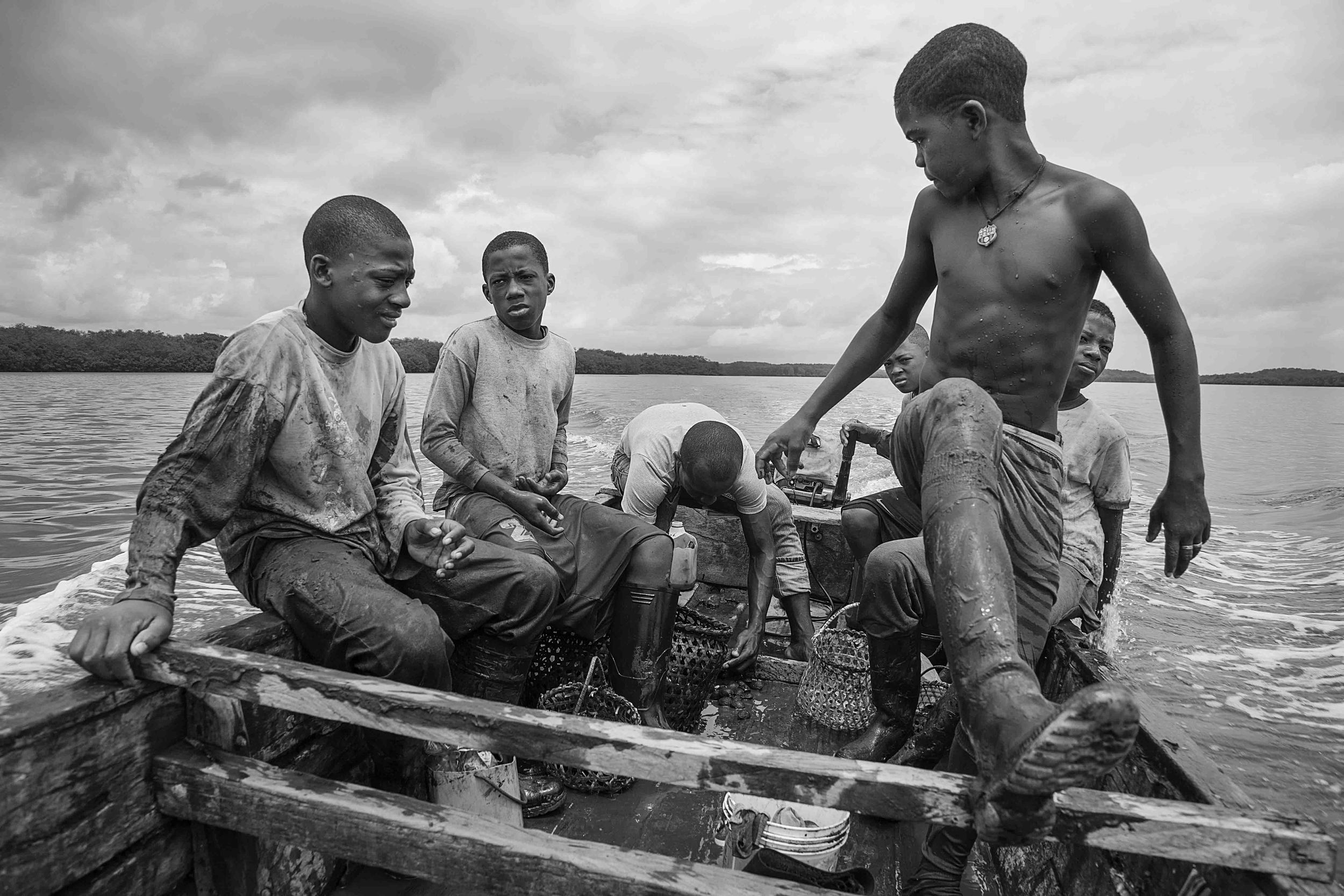  A group of kids come back from picking shells a couple of hours before the adults in order to make it to school in the afternoon. 2014 