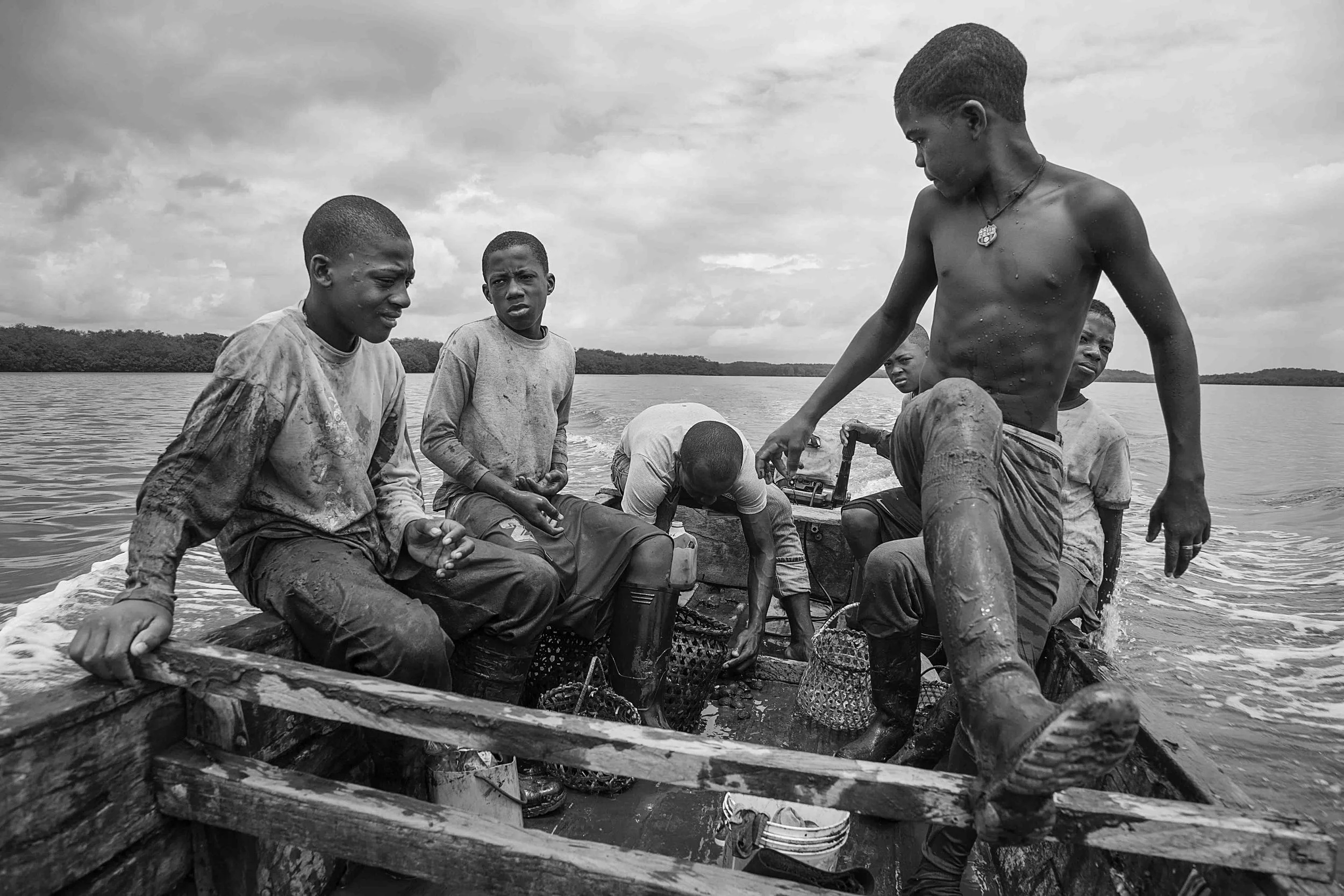 A group of kids come back from picking shells a couple of hours before the adults in order to make it to school in the afternoon. 2014