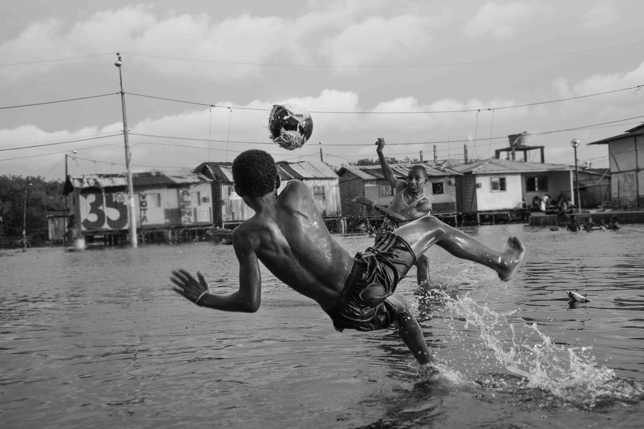  Children play soccer during the monthly high tide that floods the communities for several days in a row. The communities in the Cayapas Mataje Mangrove Reserve have absolutely no sanitation as the tides flood any kind of improved facilities. The wat