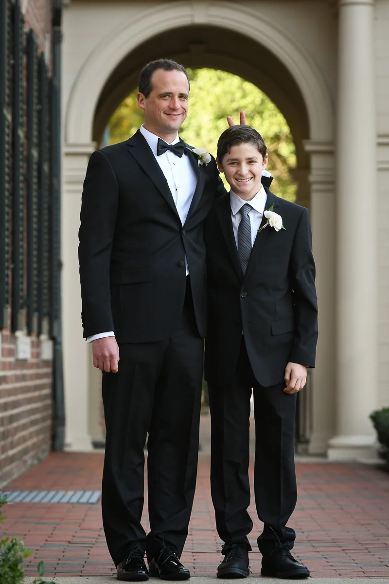 If you are the groom, you are allowed to make bunny ears behind anyone... including your little brother!