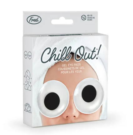 Pamper yourself with the Chill Out Googly Eyes Gel Eye Pads by Fred & Friends, shown here in gift-ready packaging on a relaxing spa day model.