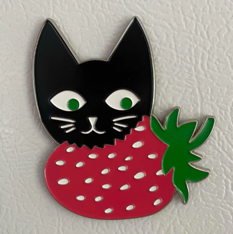 A cute Strawberry Cat magnet with a pink cat wearing a red strawberry-shaped hood.
