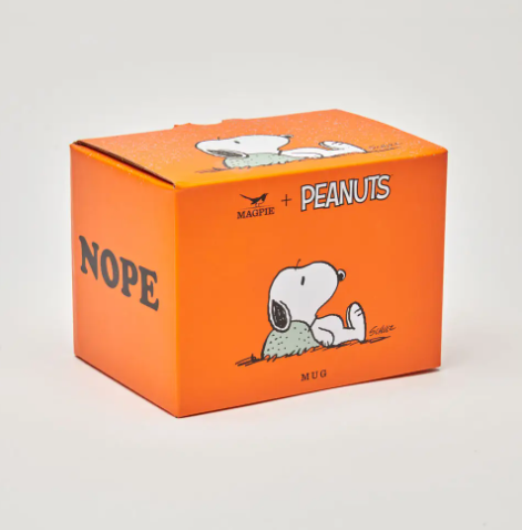 The Peanuts Nope Mug sitting next to its bright orange gift box, showcasing the playful design and gift-ready packaging.