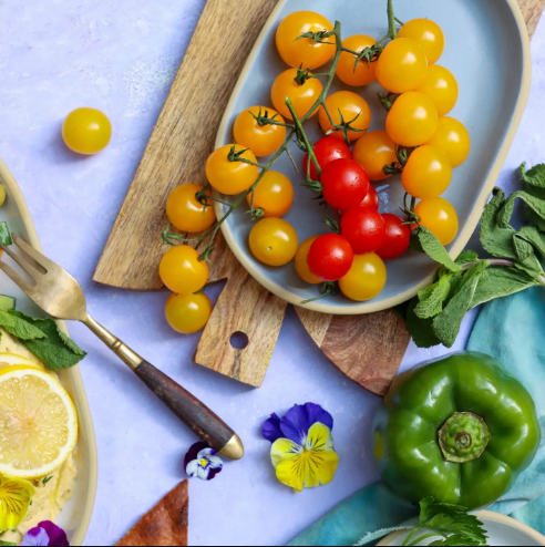 Showcase your culinary creations with the versatile Brookline Ceramic Tray by Emerson Creek Pottery, styled with fresh vine tomatoes and vibrant ingredients.