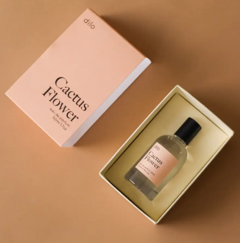 A 50ml clear glass bottle of dilo Cactus Flower perfume featuring a sleek matte black sprayer and minimalist labels.