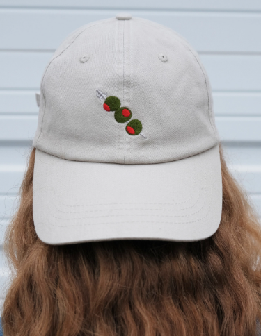 A person wearing the khaki olive-embroidered baseball cap, showcasing its casual fit and everyday style.