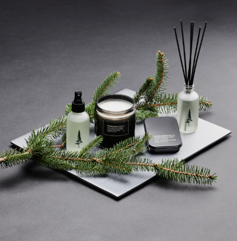 A close-up of the Great North Woods Incense Cones and tin, showcasing the product packaging and the hand-dipped quality.