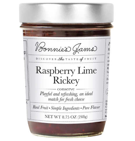 A jar of Raspberry Lime Rickey Jam by Bonnie's Jams with a clean white label, highlighting the natural color of the jam inside.