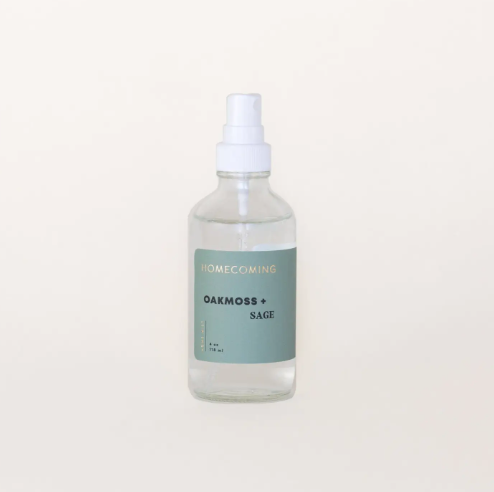 Elevate your living space with the Homecoming Oakmoss + Sage Home Mist, presented in its sleek bottle, ready to deliver a calming and sophisticated aroma.