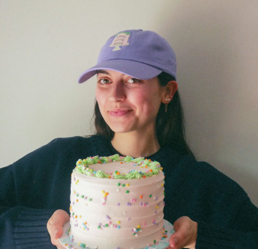 Model showcasing the relaxed fit and antiqued brass buckle of the Jenny Lemons Confetti Cake Embroidered Hat, perfect for a laid-back yet playful look.