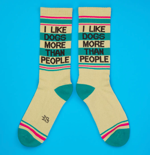 A pair of socks expressing a preference for dogs over people, highlighting the mid-calf length and ribbed texture.