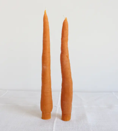 Brighten up your tabletop with a whimsical pair of orange carrot taper candles, featuring organic textures cast from real vegetables and finished with clean-burning cotton wicks.