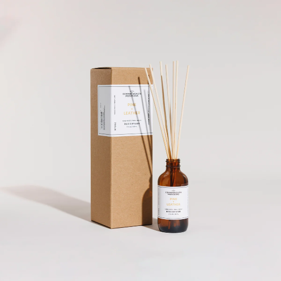 Close-up of the Pine + Leather Reed Diffuser showing the reeds and fragrance oil.