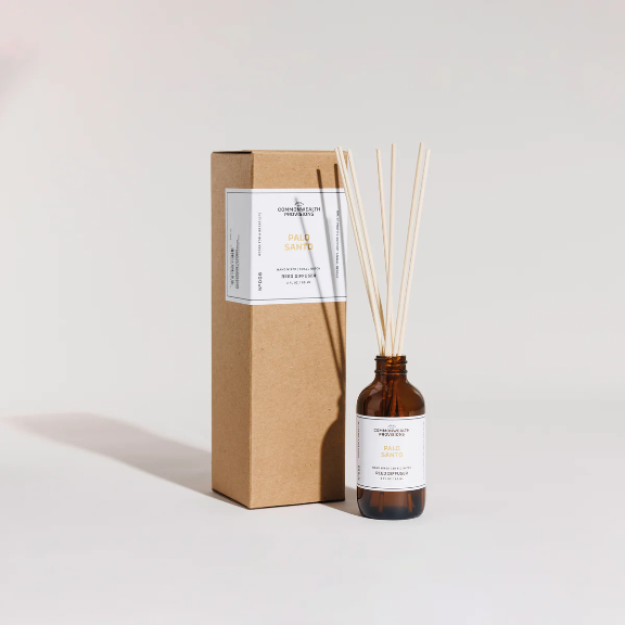 Close-up of the Palo Santo Reed Diffuser showing the reeds and fragrance oil.