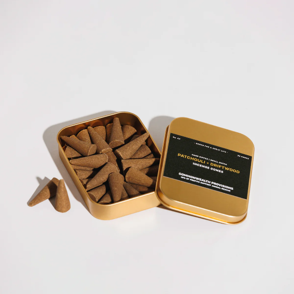 Patchouli + Driftwood Incense Cones by Commonwealth Provisions: The tin packaging displayed alongside the incense cones, perfect for creating a calming atmosphere.