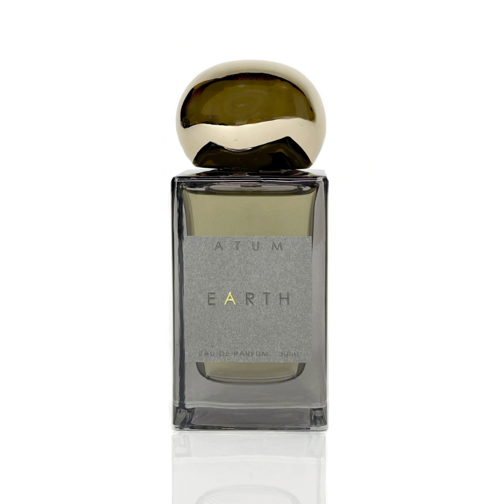 Earth Parfum by ATUM: A sophisticated tinted grey glass bottle with a magnetic gold topper, showcasing the luxurious fragrance inspired by the natural world.