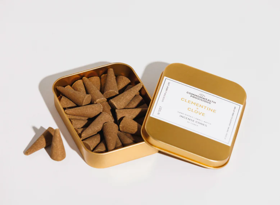 Clementine + Clove Incense Cones by Commonwealth Provisions: The tin packaging displayed alongside the incense cones, perfect for creating a sweet and spicy atmosphere.