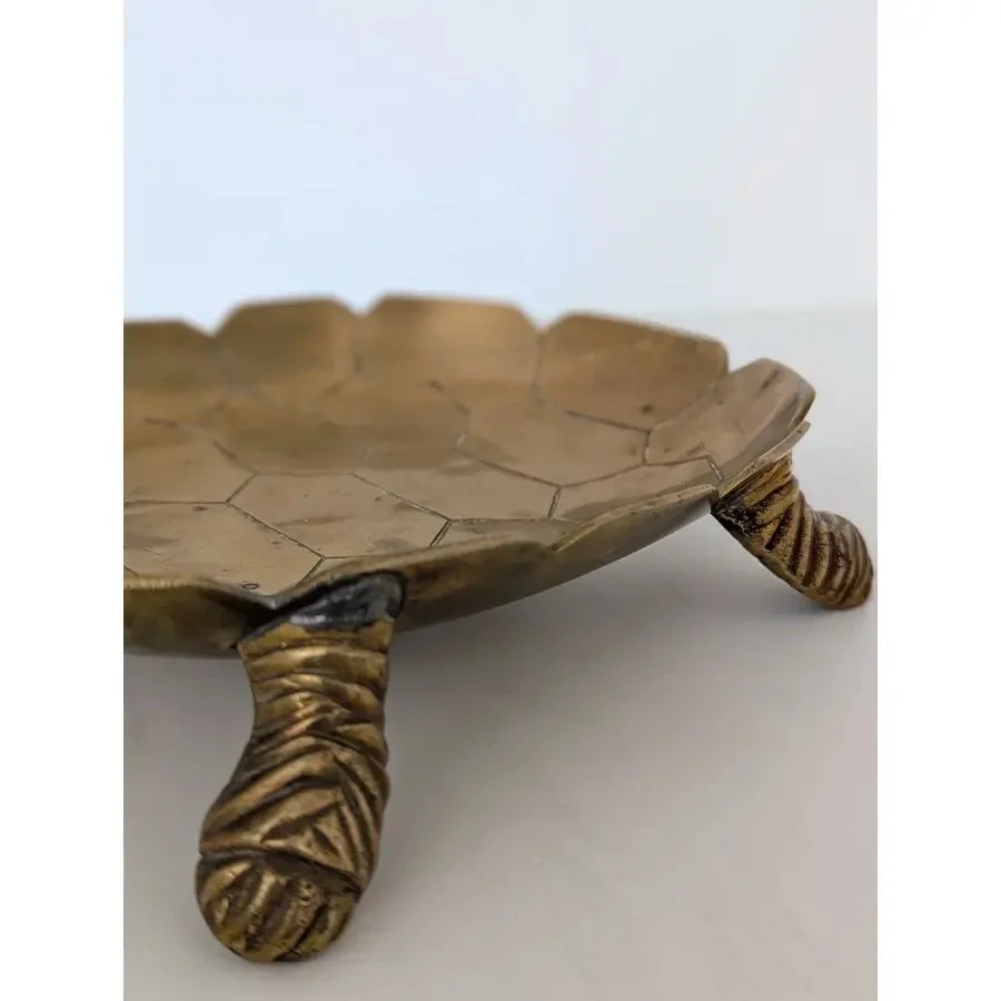 1970s tortoise-shaped catch-all bowl made of brass on white background