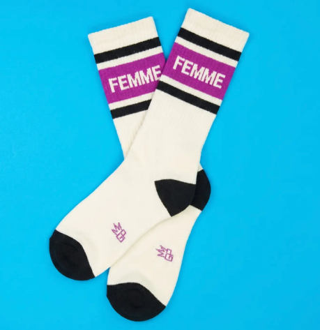 Showcase your style with American-made identity socks displaying solid black heel and toe caps, a wide ribbed top, and crisp white block text graphics across the leg.