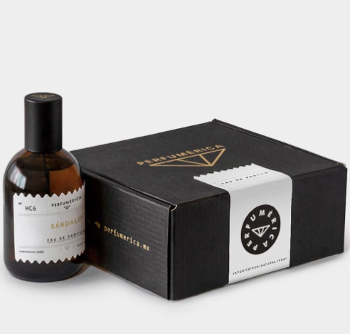 A close-up view of the minimalist Sandalo Eau de Parfum bottle, featuring its distinctive apothecary-style label.