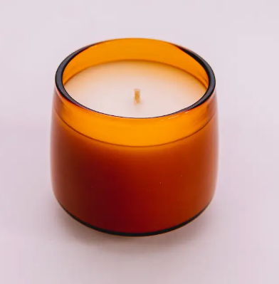 Reusable amber glass candle vessels from Sonder Goods that transition into heat-resistant drinking glasses after use.