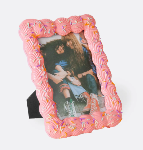 Display your happiest moments in a whimsical 4x6 tabletop frame featuring an easel back and a fun, dessert-themed design covered in faux rainbow sprinkles.