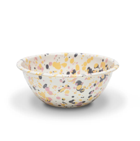 Catalina Small Serving Bowl in Pink Sunset, showcasing its unique enamel splatter design and smooth, curved shape.