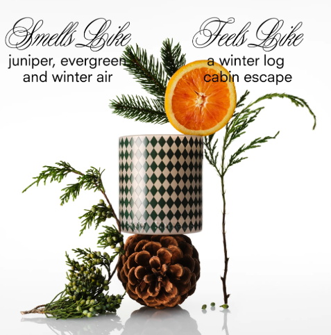 A luxury candle with a woody/fresh scent, packaged for the holidays.