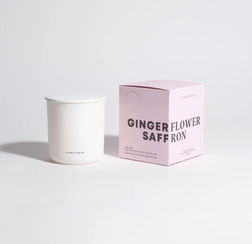Experience the captivating aroma of the Homecoming Ginger Flower Saffron Soy Wax Candle, elegantly presented in its minimalist vessel and pink gift box, ready to transform your space.
