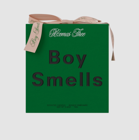 The green box of the Boy Smells Xxmas Tree candle tied with a pink ribbon.