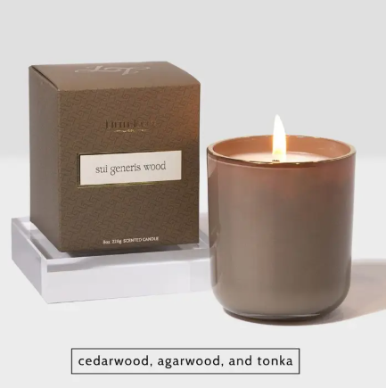 Little Torch Sui Generis Wood candle, featuring a rich, woody-toned vessel and box, glowing with warmth to bring a cozy cabin retreat ambiance into any room.