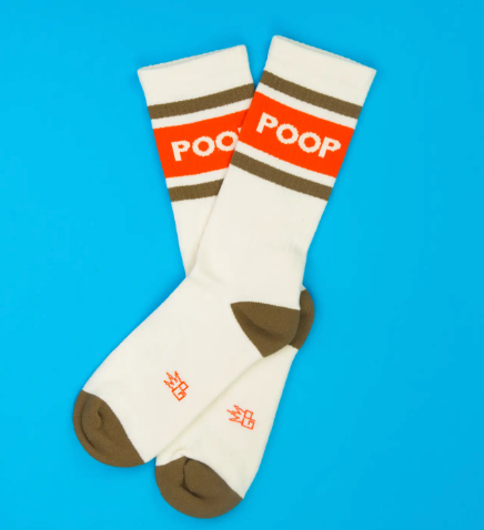 Coordinate your sneakers with American-made statement socks displaying solid brown heel and toe caps, a wide ribbed top, and bold text graphics across the leg.