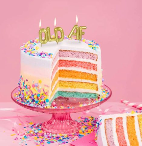 Celebrate milestone birthdays with humor using the Lighten Up Party Old AF Candles by Fred & Friends, displayed on a colorful frosted layer cake.