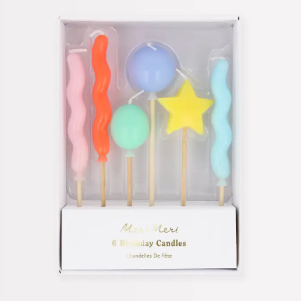 A boxed set of six vibrant 3D molded balloon and star candles by Meri Meri, showcasing a playful assortment of bright colors.