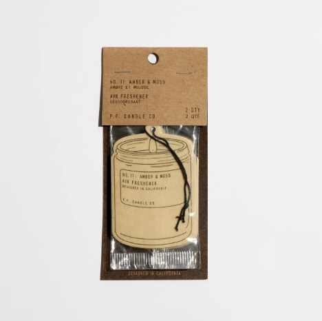 A pair of candle-shaped air fresheners with a brown kraft paper finish and black string for hanging.