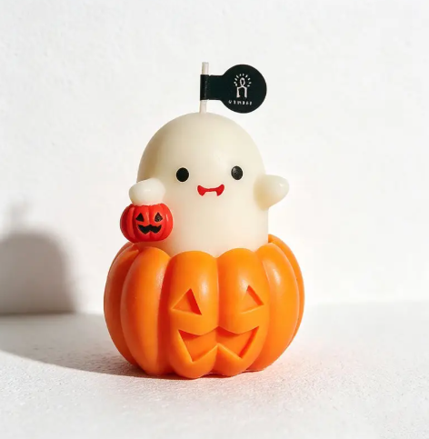 Delight guests with the Ghost Pumpkin Candle Style 4 by CouldNook, featuring a cheerful ghost clutching a miniature pumpkin.