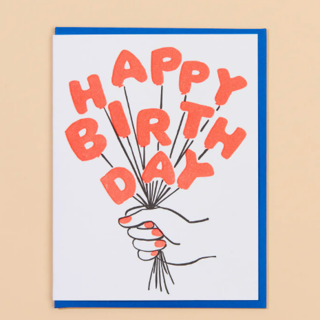 A vibrant neon letterpress birthday card featuring a bouquet of colorful balloons and a hand with a bright red manicure.