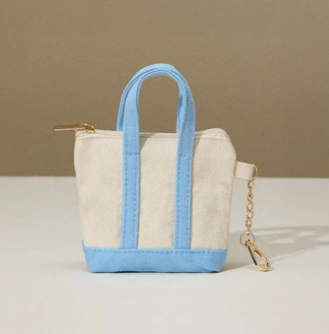 Clip on the Blue Mini Canvas Pouch Bag Charm by Sensibling Corp., crafted from 100% cotton with a secure zipper.
