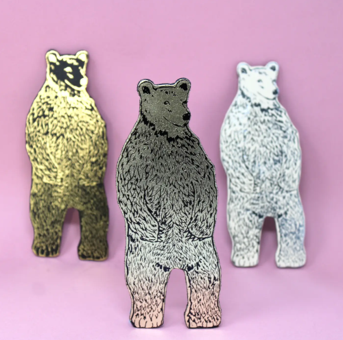 Gold bear magnet by Ark Colour Design, showcasing its detailed hand-embossed texture against a solid background.